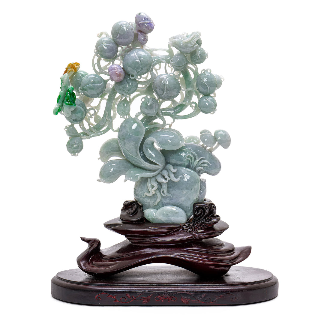 Hand-carved jade peach tree with bird sculpture.