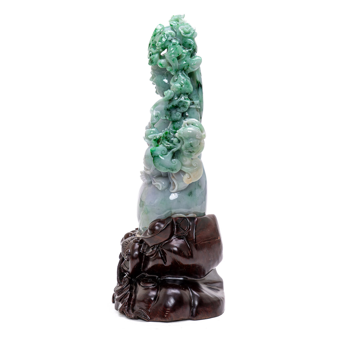 Serene Buddha sculpture holding a peach branch, symbol of longevity.