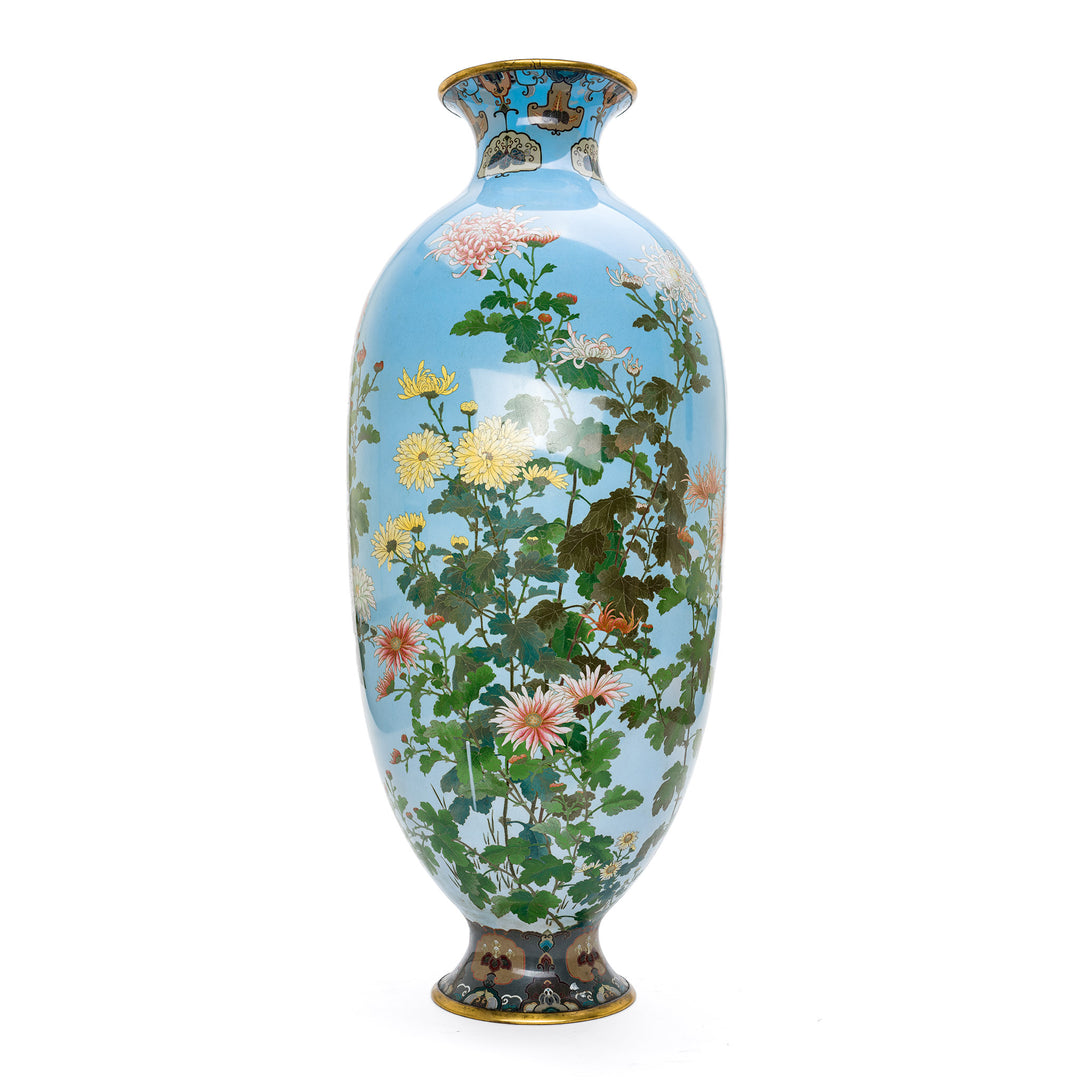 Japanese Cloisonné vase with intricate floral design on blue background