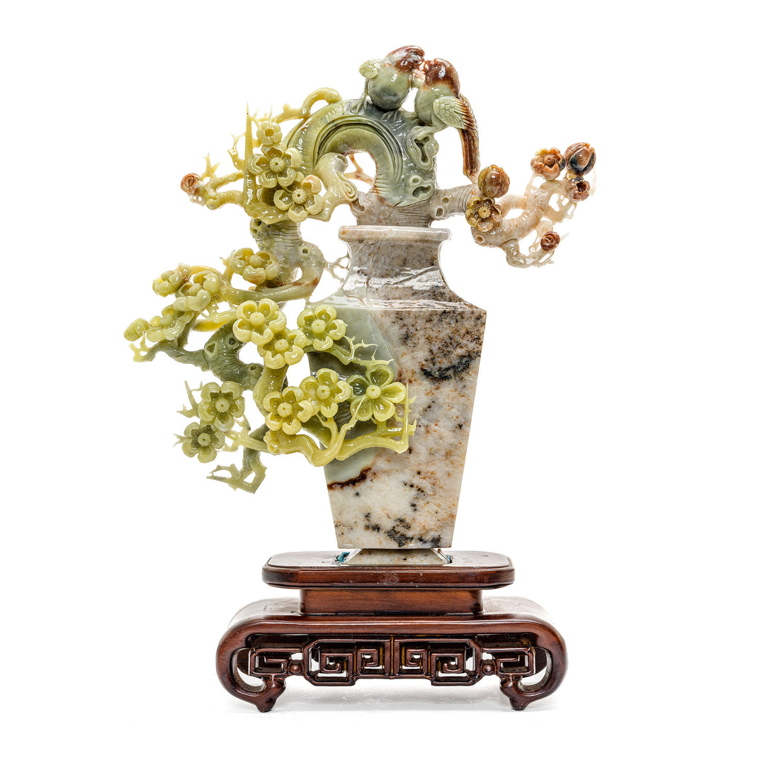 Agate sculpture of plum blossoms and perched songbirds on a vase.