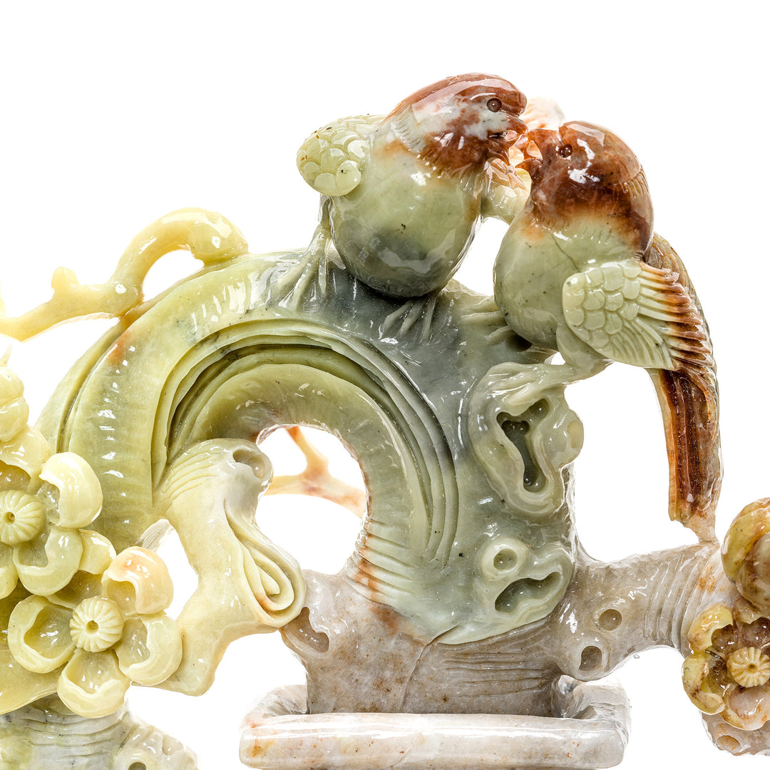Nature-inspired agate sculpture with blossoms and songbirds.