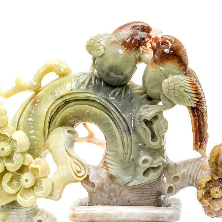 Nature-inspired agate sculpture with blossoms and songbirds.