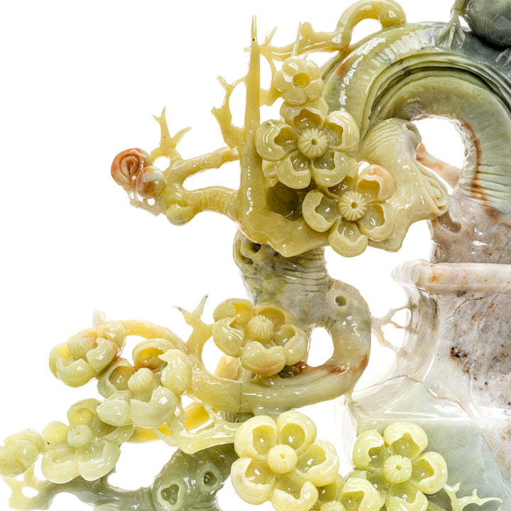 Elegant agate songbird figures on a blooming plum blossom branch.