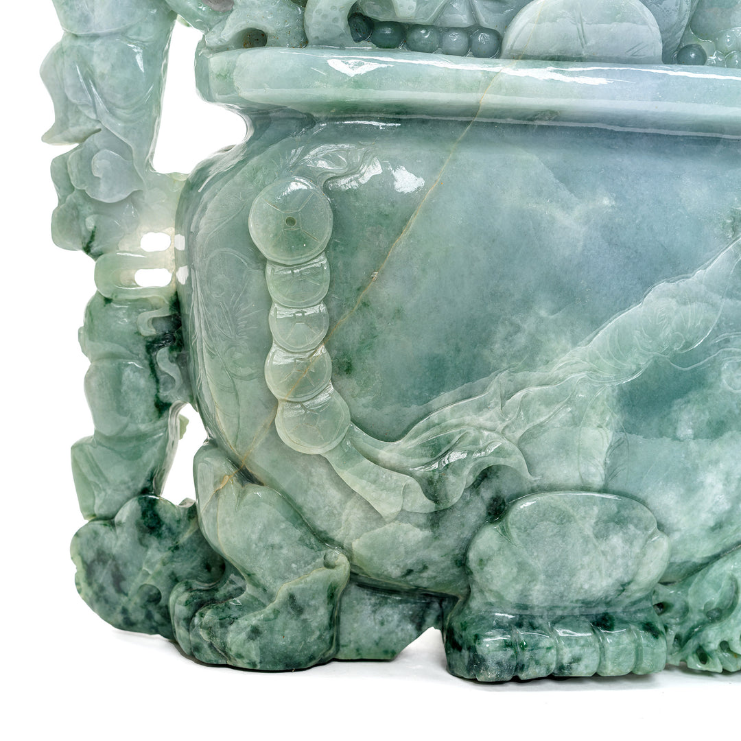 Cultural jade artifact of a flower pot intertwined with money.