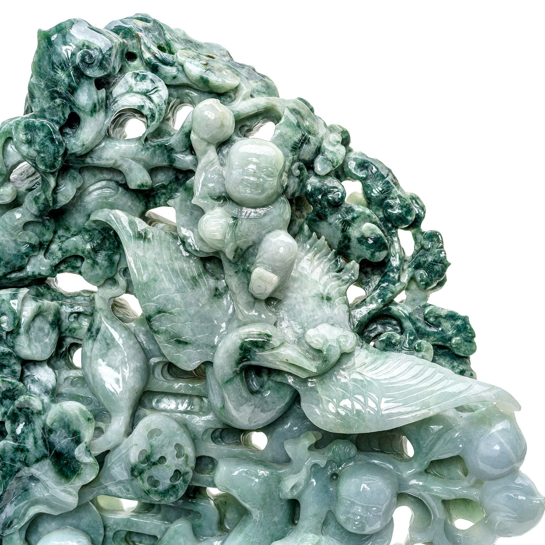 Hand-carved jade prosperity flower pot on a traditional stand.