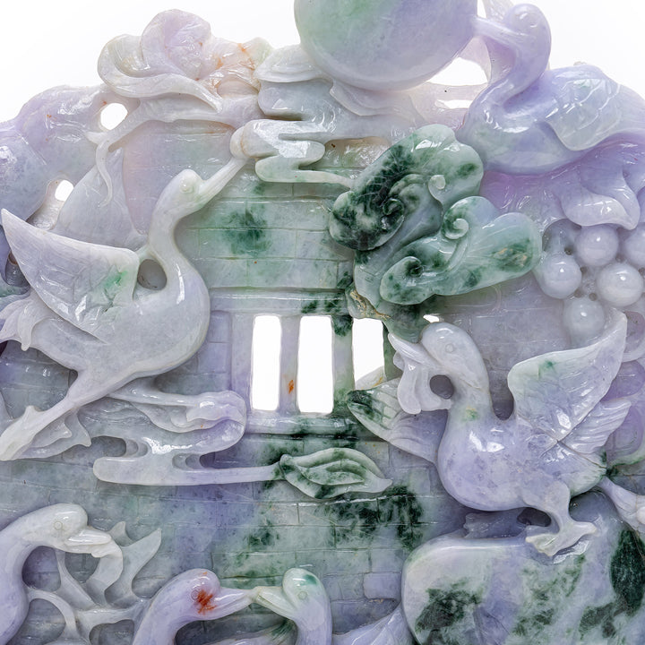 Elegant jade boulder capturing the playful frolic of geese amongst abundant grape vines.