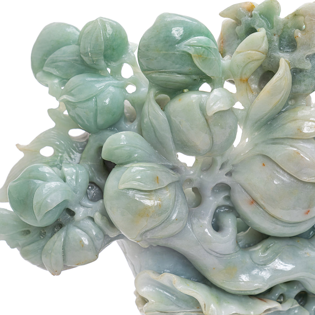 Jade dragon boat with Buddha's hand and lush vegetation.