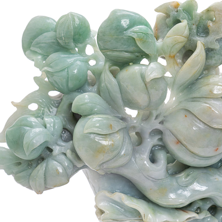 Jade dragon boat with Buddha's hand and lush vegetation.