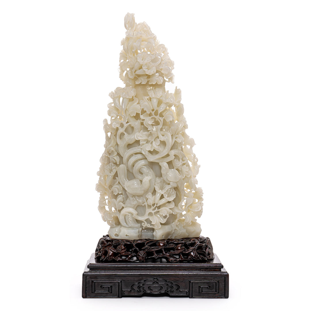 Rare white jade bird sculpture with floral motifs.