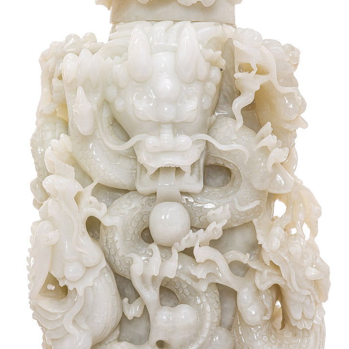 Hand-carved jade dragons fighting for wisdom's pearl.