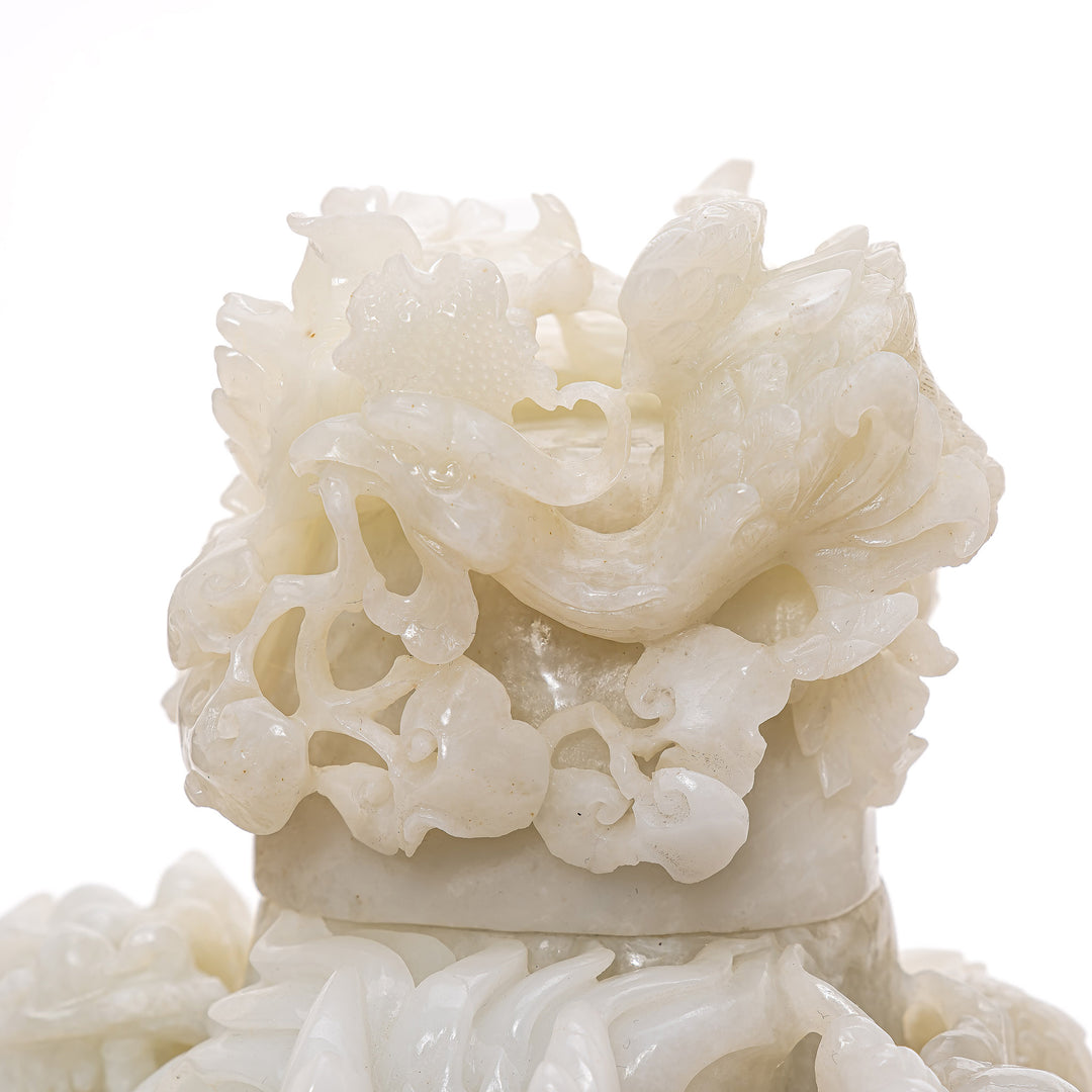 Rare jade dragon sculpture with floral motif cover.