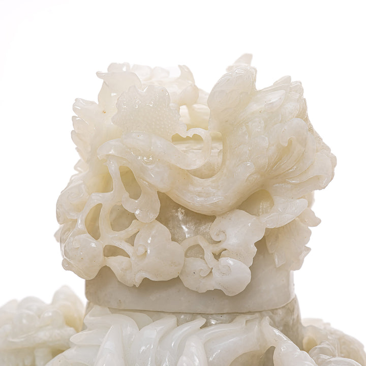 Rare jade dragon sculpture with floral motif cover.
