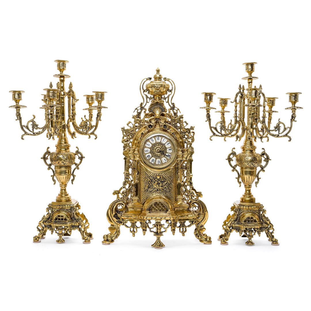 Luxurious Gilt Bronze Timepiece Flanked by Ornate Candelabras.Exquisite Gilt Bronze Candelabras with Busts of Cherubs and Wreath Swags.