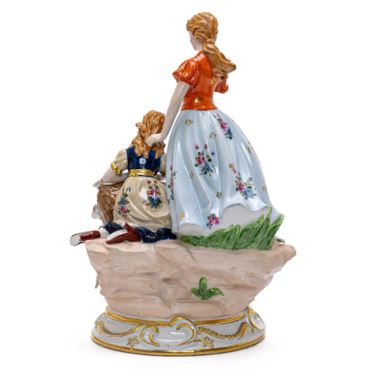 Delicate porcelain art featuring ladies in period attire with swans.