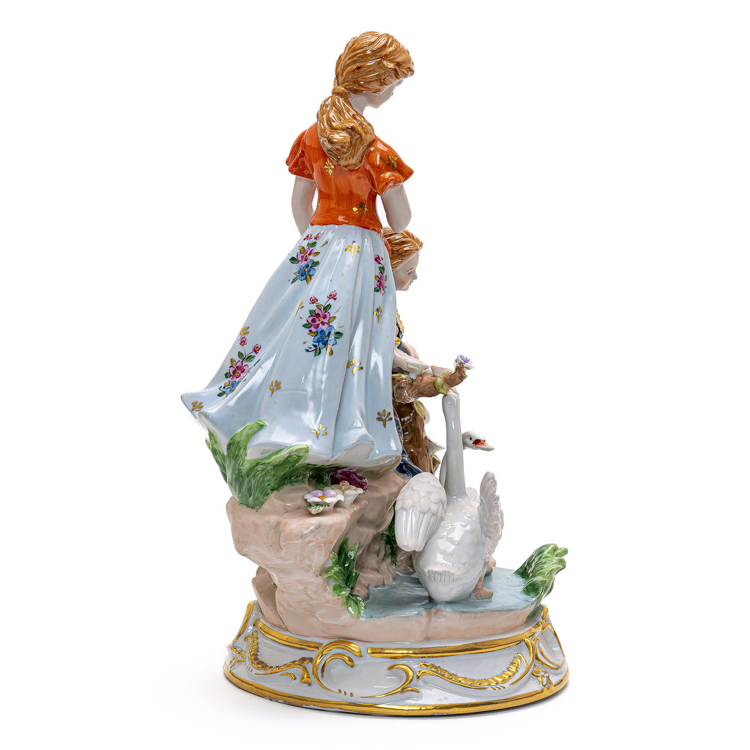 Intricate handmade sculpture of aristocratic ladies alongside swans.