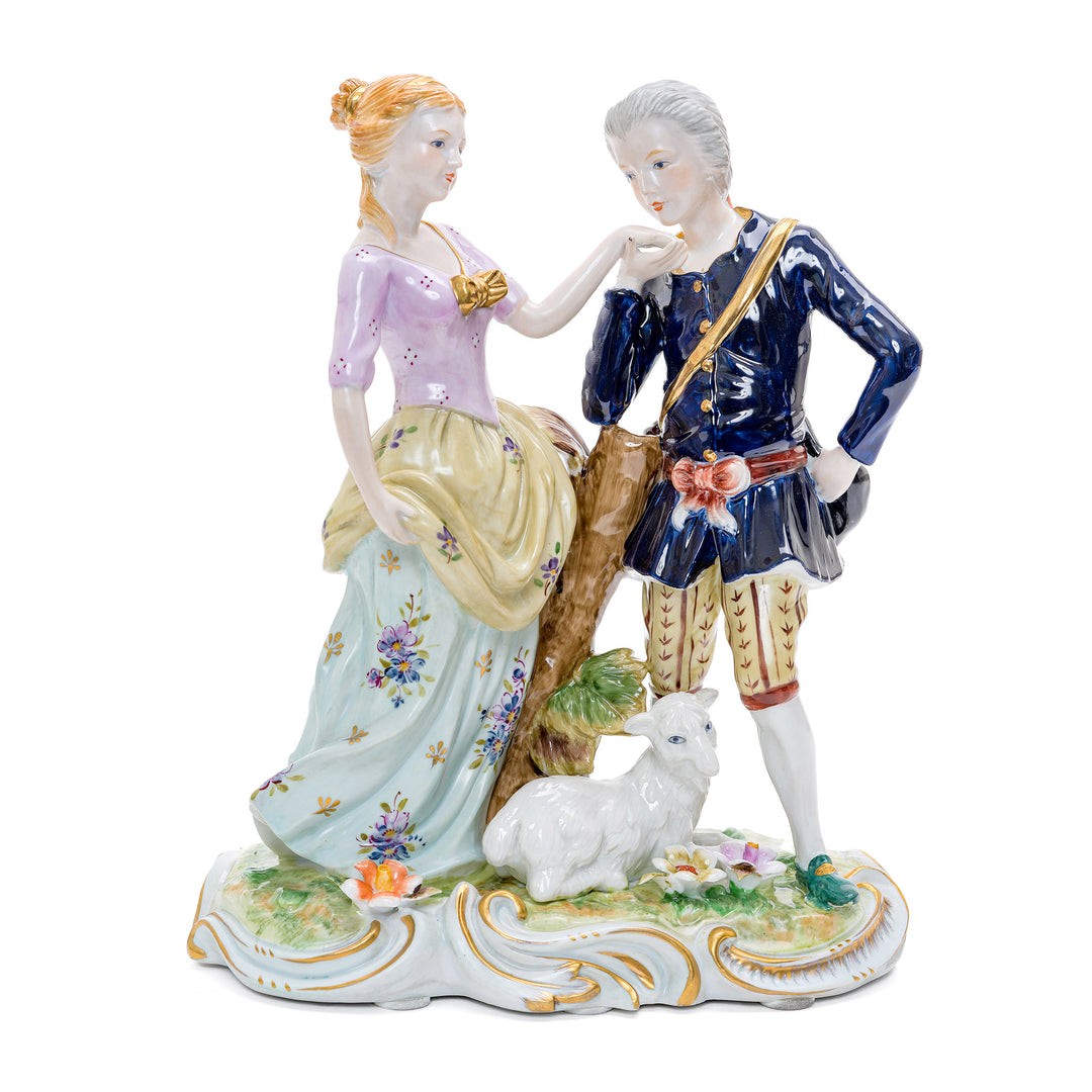 Handmade porcelain sculpture of a gentleman kissing a lady's hand with a goat at their feet.