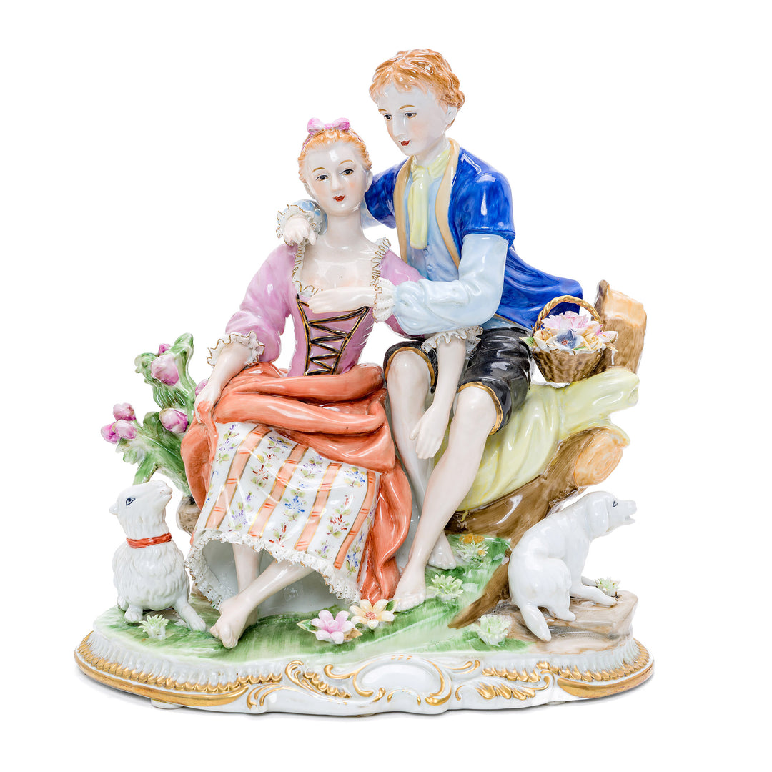 Handmade porcelain sculpture of a seated young couple with a dog and goat.