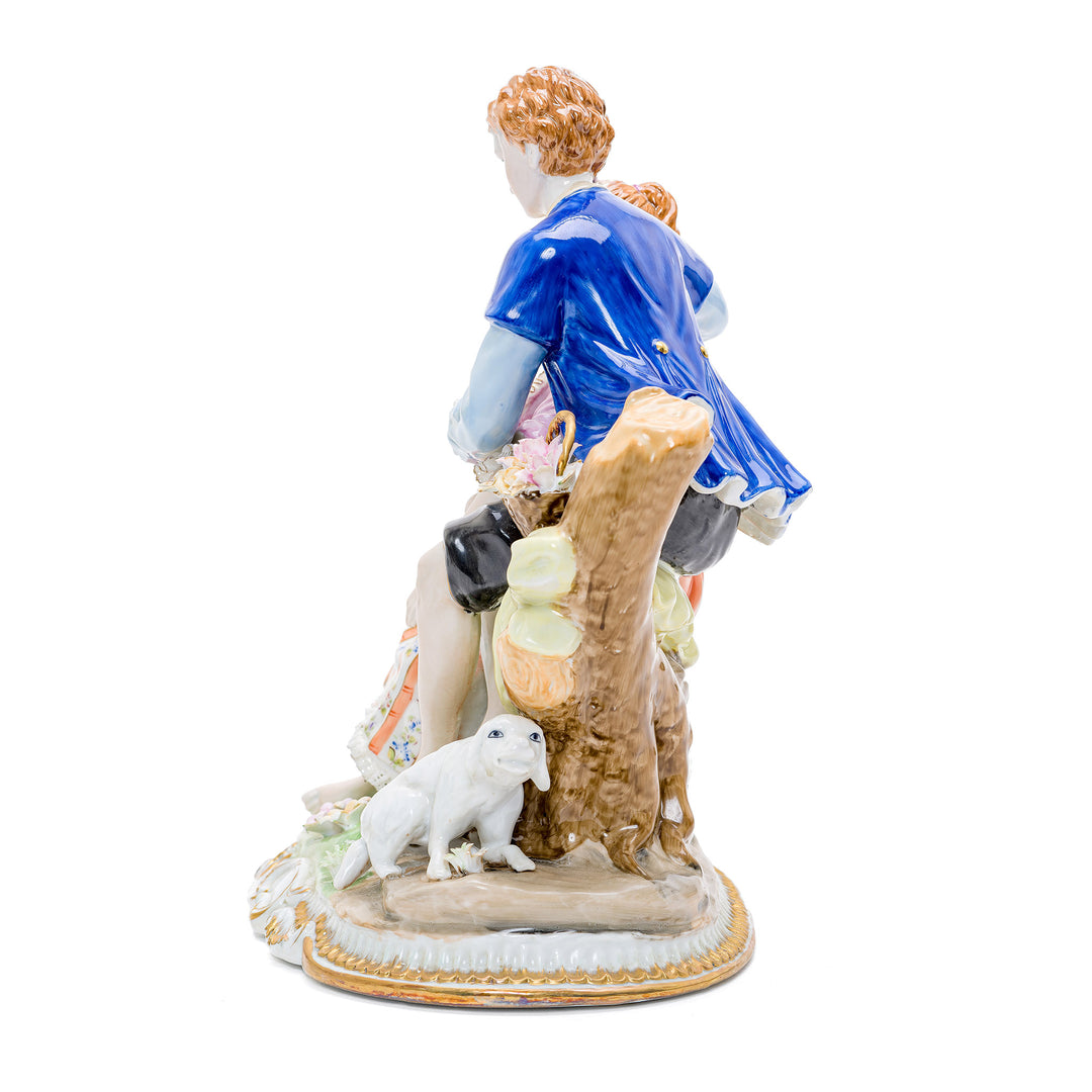 Intricate porcelain figurine depicting rustic romance with pastoral animals.