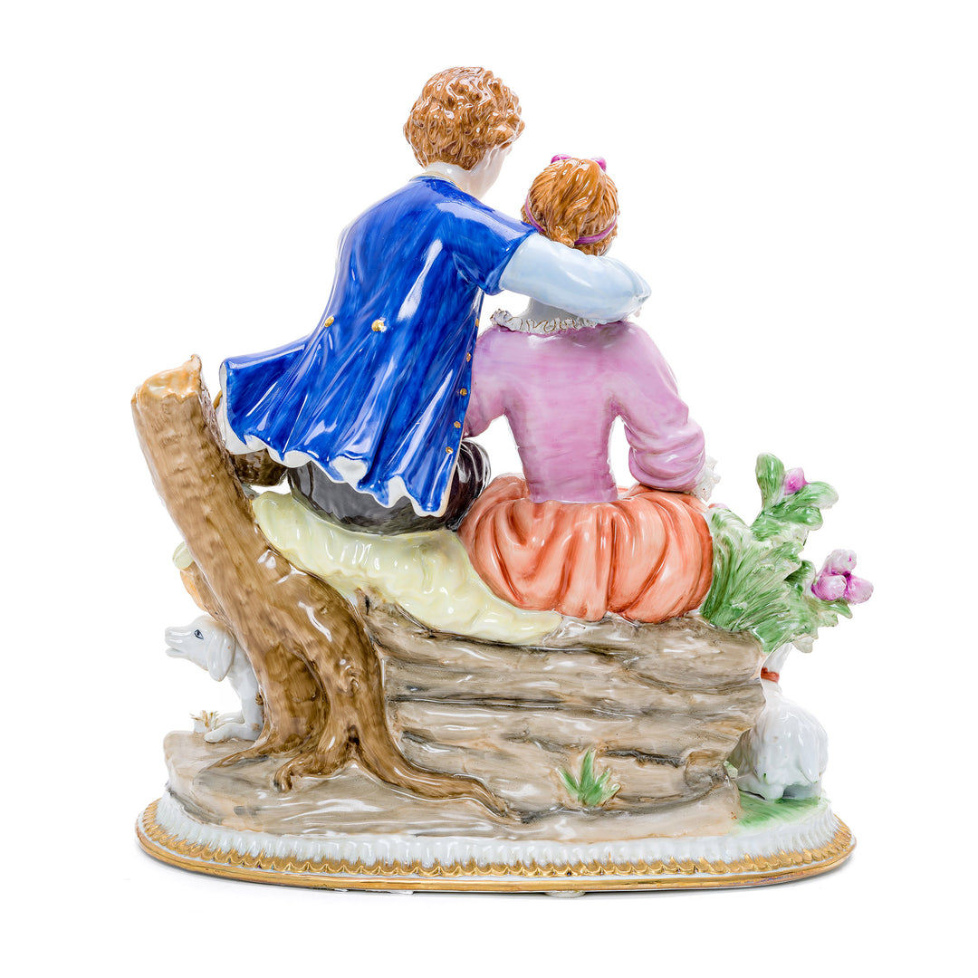 Charming porcelain piece showcasing young love and animal companionship.