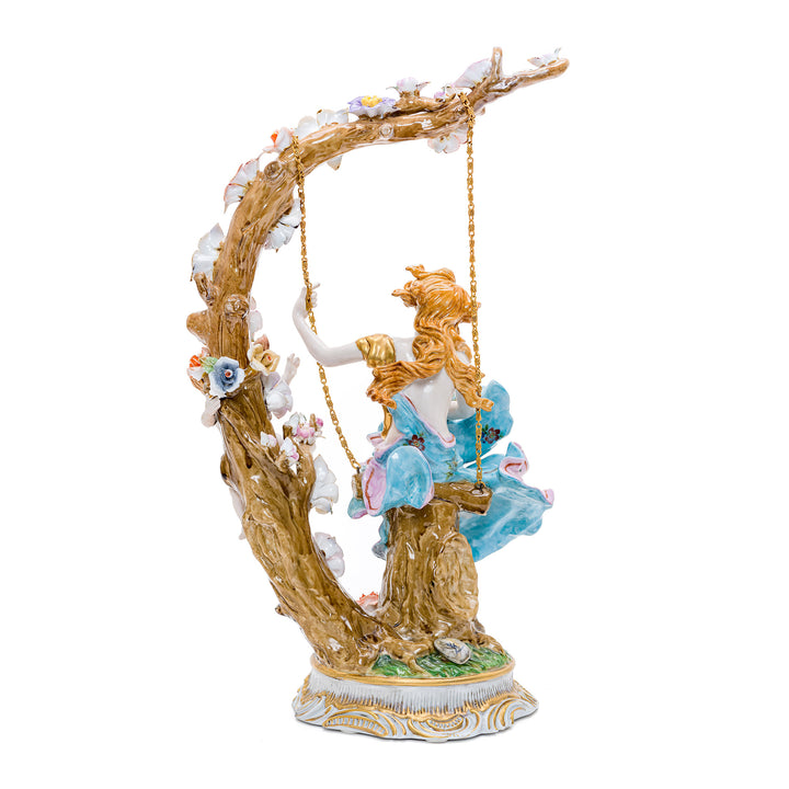 Whimsical handmade porcelain art of a young woman and cherub amid flowers.