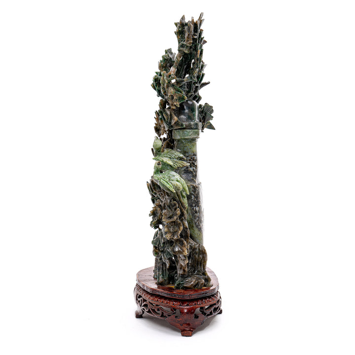 Jade masterpiece showcasing cranes dancing in a forest setting.