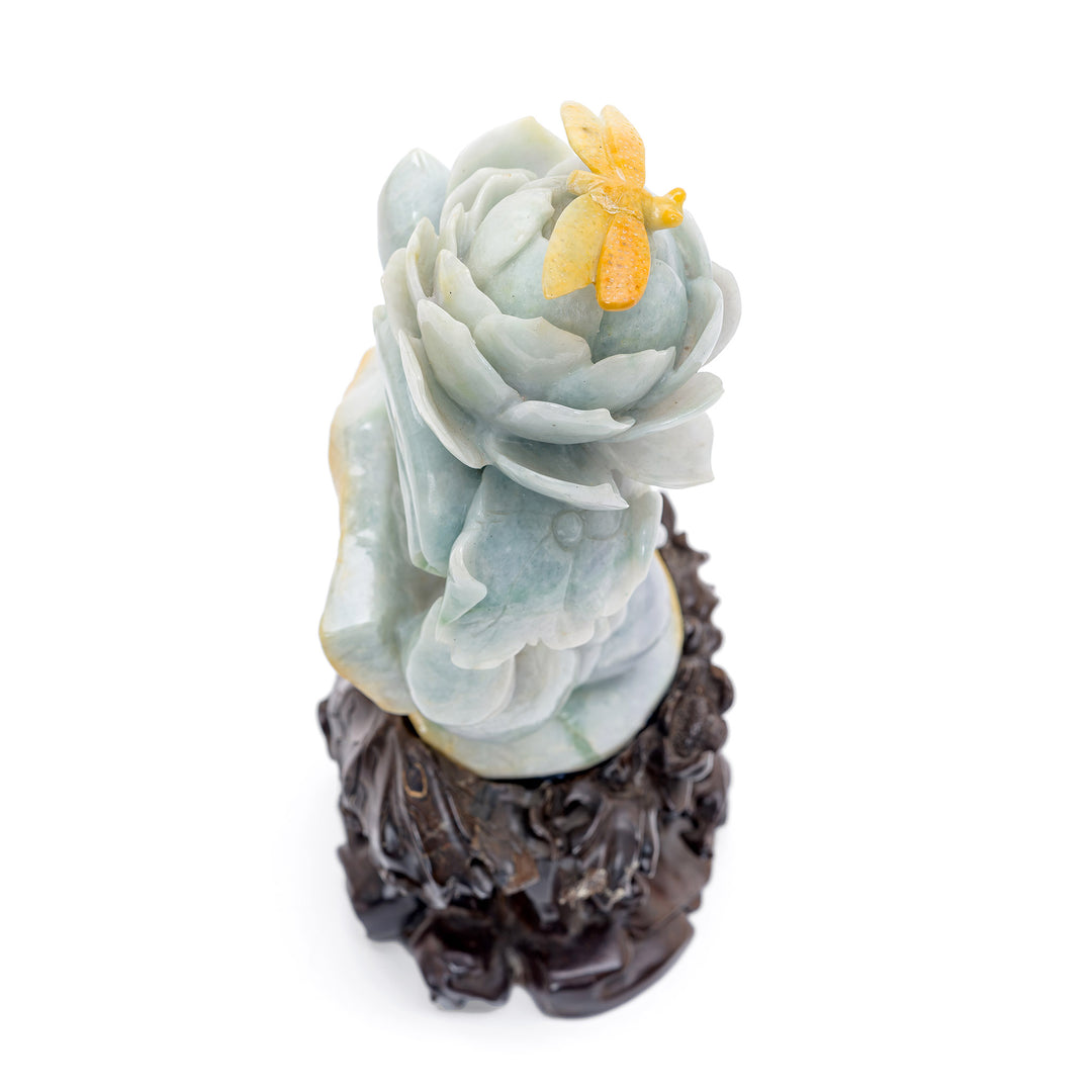 Ethereal jade sculpture of a peony flower with a poised dragonfly visitor