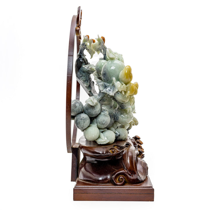 Symbolic agate carving of peaches for prosperity and longevity.