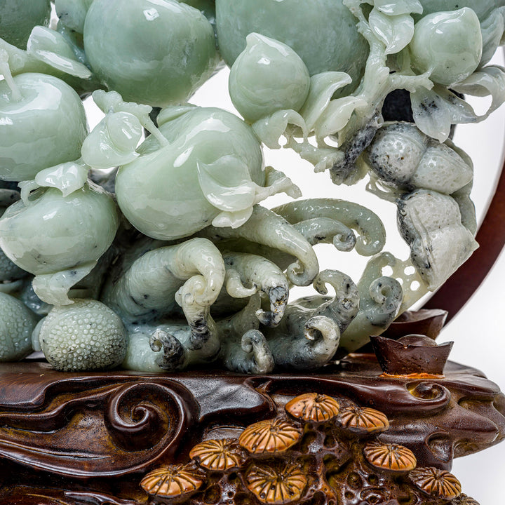 Agate fruit carving showcasing a bounty of peaches.