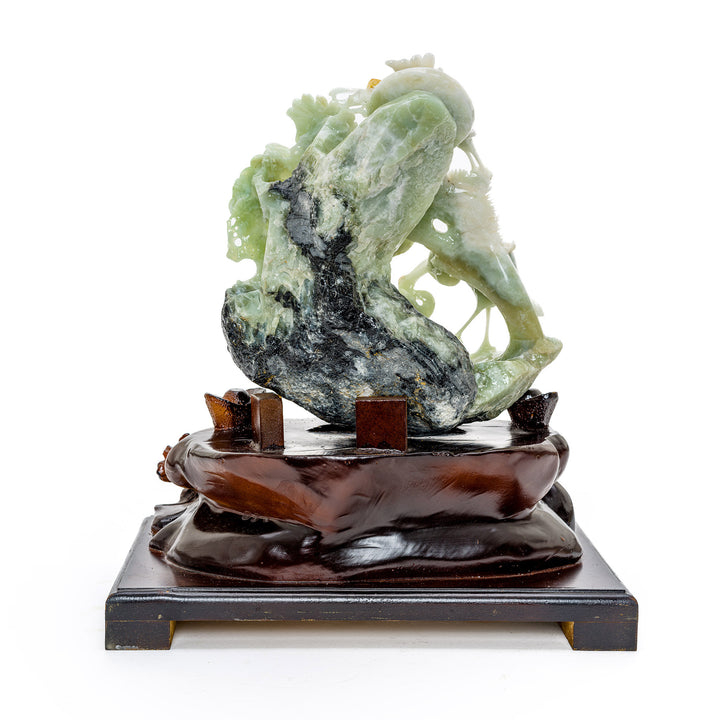 Carved agate cranes in peaceful assembly, a symbol of harmony.