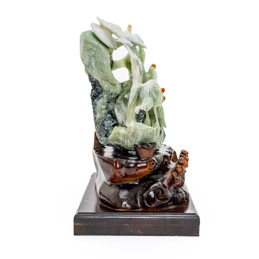 Lifelike crane sculpture in agate, poised on a natural hillside.
