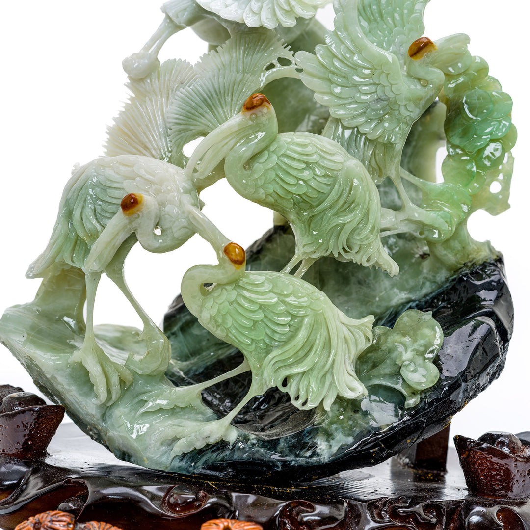 Artisanal hillside crane group in agate, reflecting tranquility.