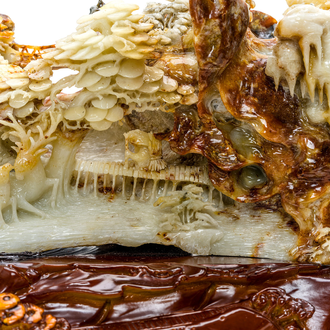 Earth-toned agate carving of a tranquil village landscape
