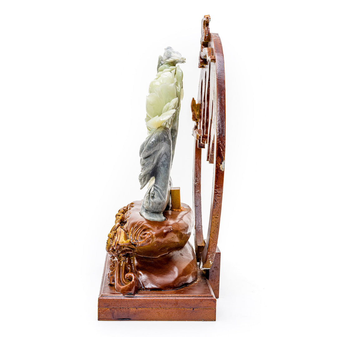 Intricate carving of peonies and avian pair in agate, symbolizing harmony.