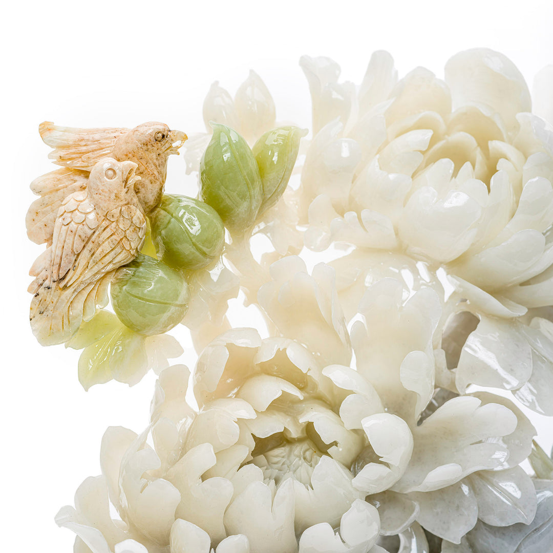 Blooming agate peony flowers with a beautifully carved bird, on a wooden stand.