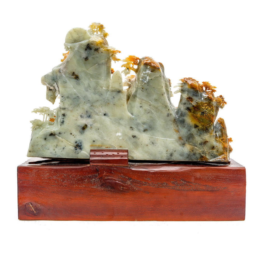 Artisan-crafted agate sculpture with dense pine trees