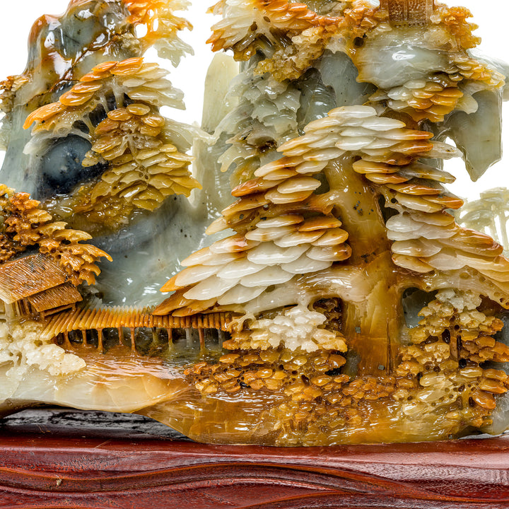 Serene agate carving of a traditional pine village