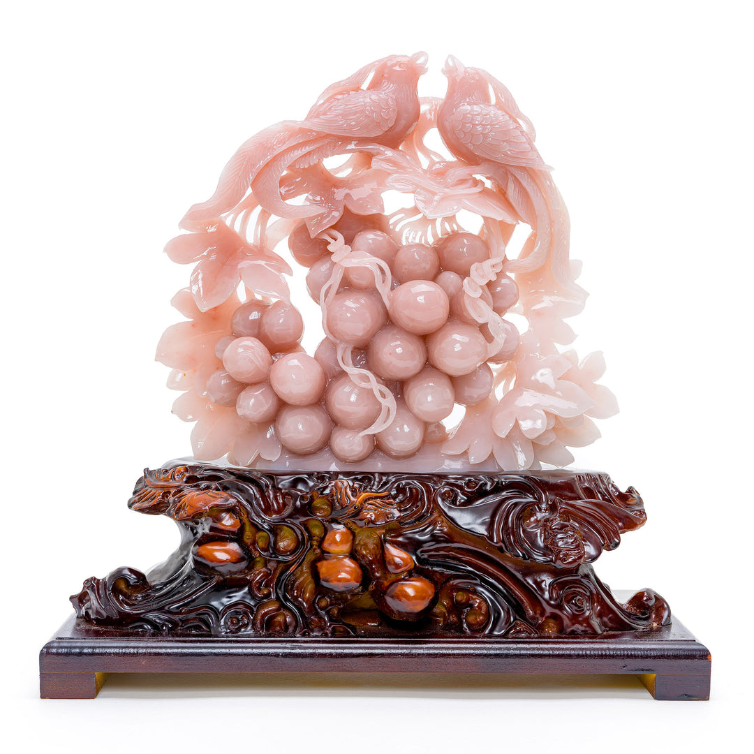 Pair of rose quartz phoenix birds perched on a grape cluster, a symbol of harmony