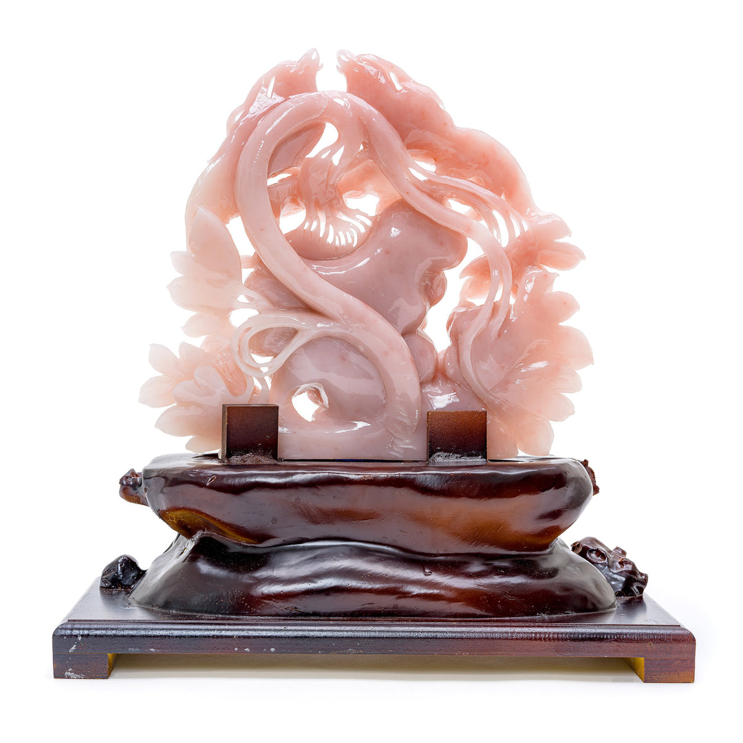 Luxurious pink quartz phoenix birds on a wooden base, reflecting natural abundance