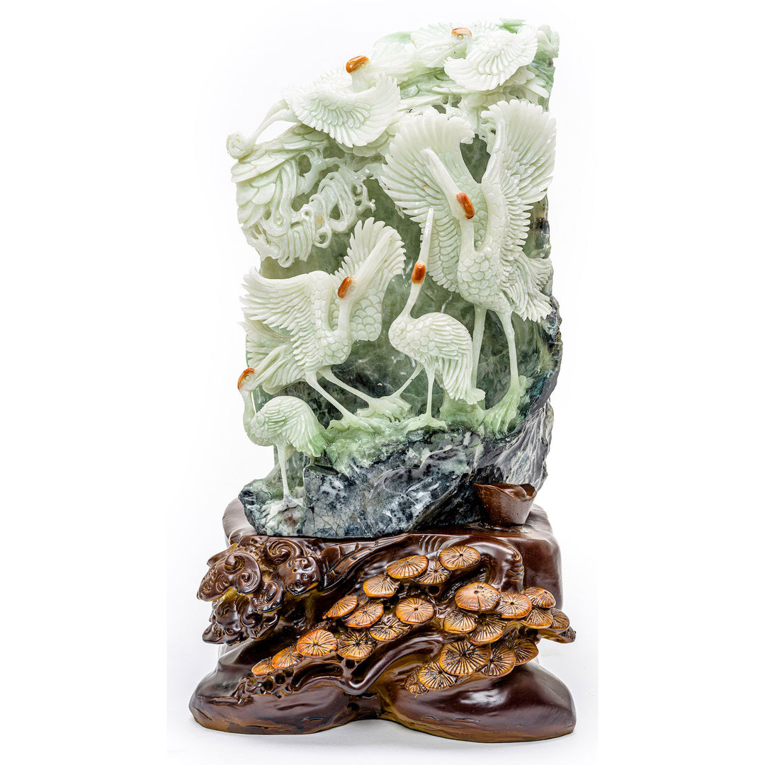 Hand-carved agate sculpture of a crane grouping frolicking on a hillside.