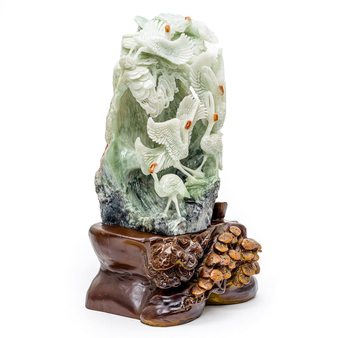 Nature-inspired agate and wood carving of graceful cranes.