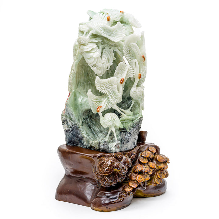 Nature-inspired agate and wood carving of graceful cranes.