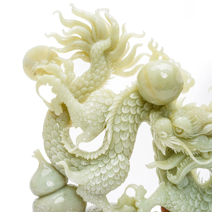 Enigmatic agate dragon sculpture with the Pearl of Wisdom on a rustic base.