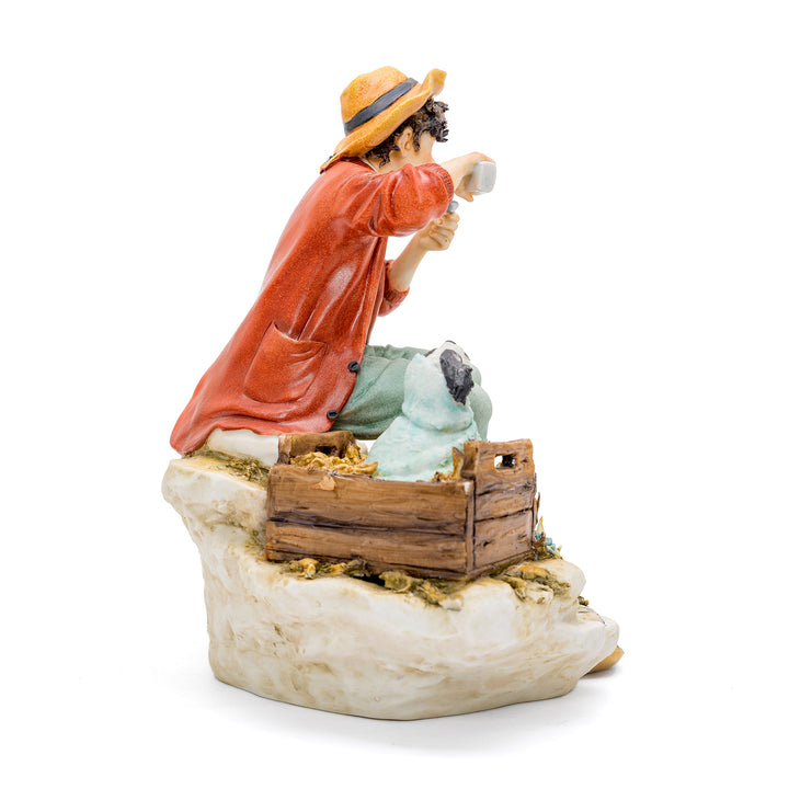 Porcelain scene of a child caring for an animal by Capodimonte.