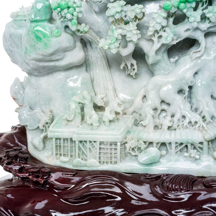 Detailed Carved Jadeite Artwork Depicting a Lush Mountain Village Scene.