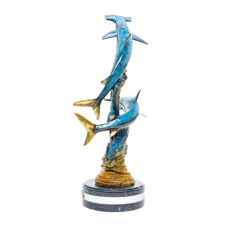 Artistic depiction of hammerhead sharks in a spiraling dance crafted in bronze