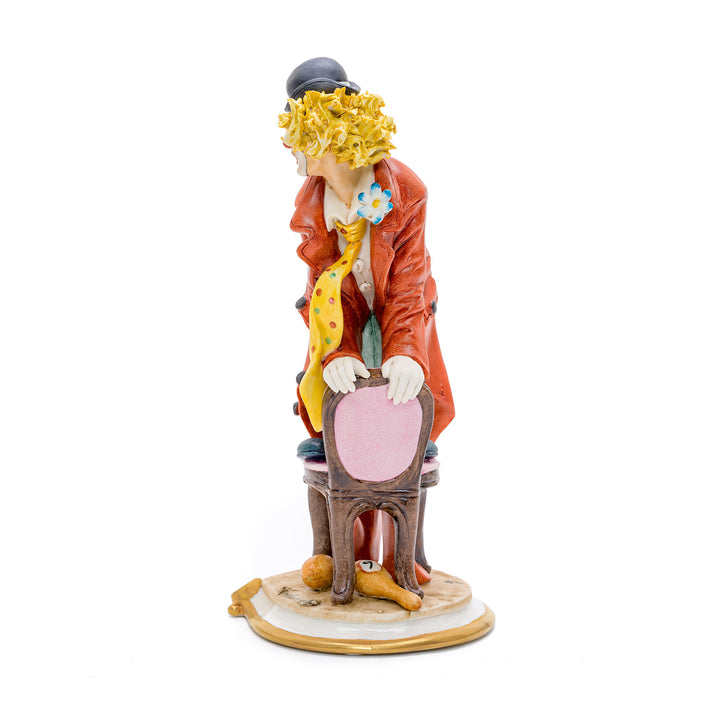 Italian crafted clown performing antics in porcelain.