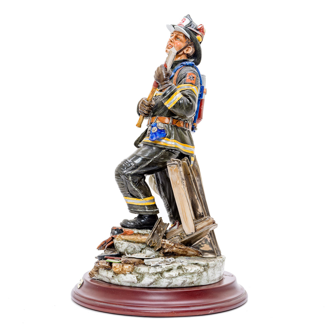Italian crafted firefighter with axe in porcelain.