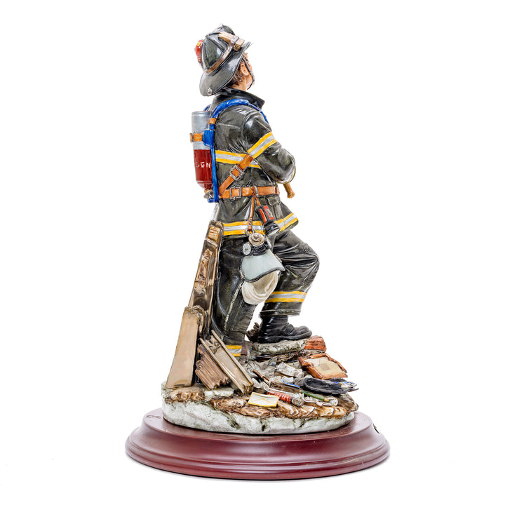 Artistic Capodimonte figurine of a fireman in action.