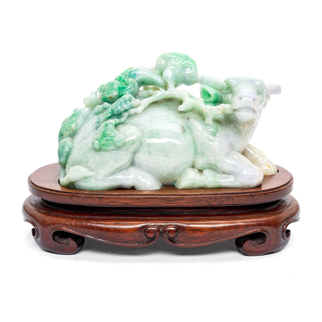 Jade cow sculpture with wood base