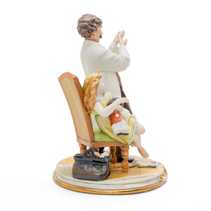 Porcelain representation of a doctor and young patient by Capodimonte.